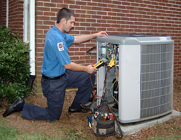HVAC technician checking a residential air conditioning system