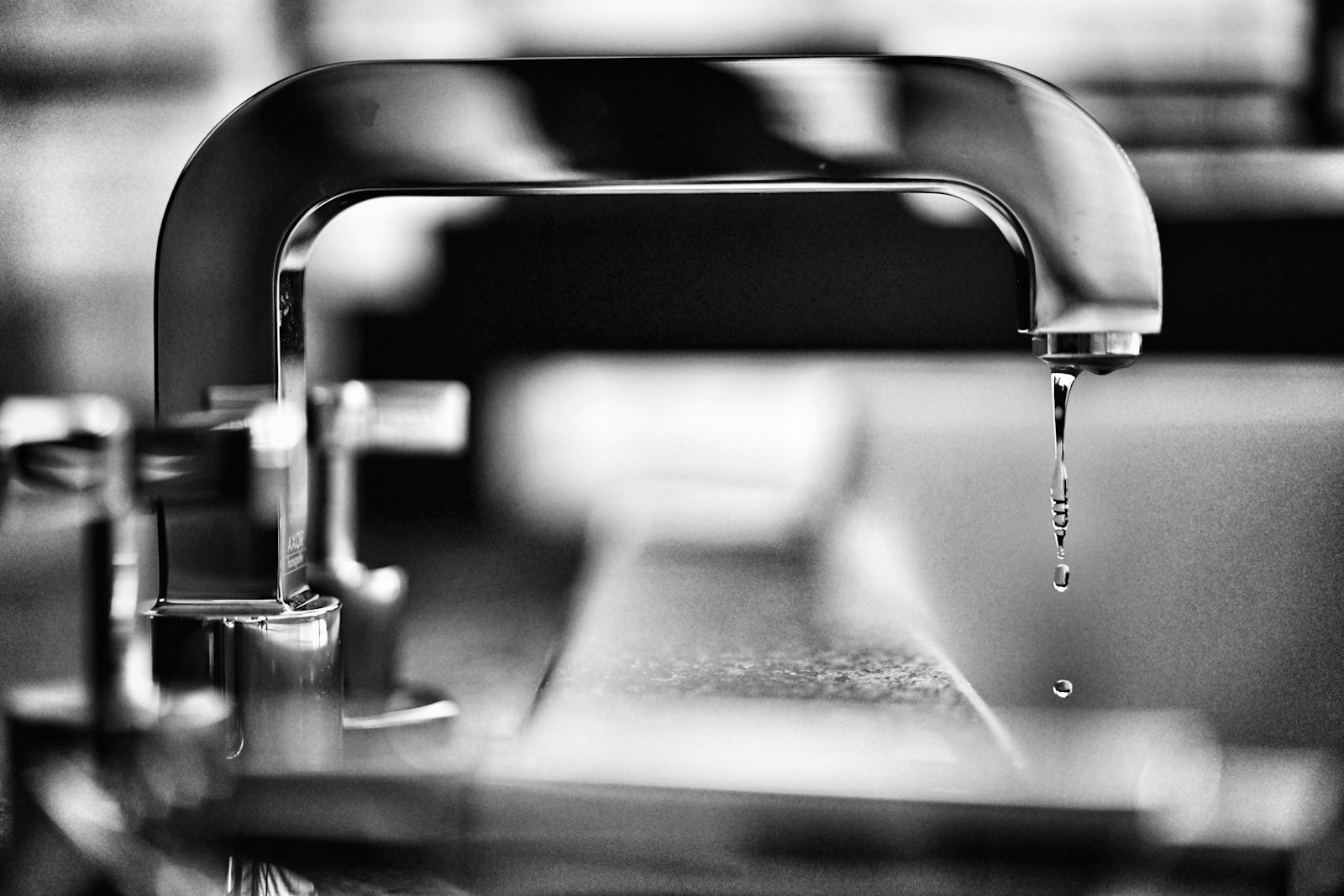 Close view of a plumber inspecting a pipe connection